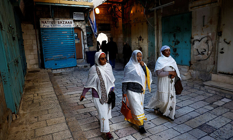 People walk past closed shops during a strike as a protest against the killing of senior Hamas official, Saleh al-Arouri, in Jerusalem&rsquo;s Old City. &mdash; Reuters