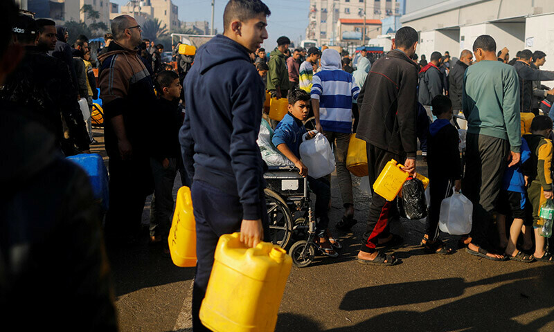 Palestinians queue as they wait to collect drinking water, amid shortages of drinking water in Rafah, in the southern Gaza Strip January 4, 2024.  &mdash; Reuters