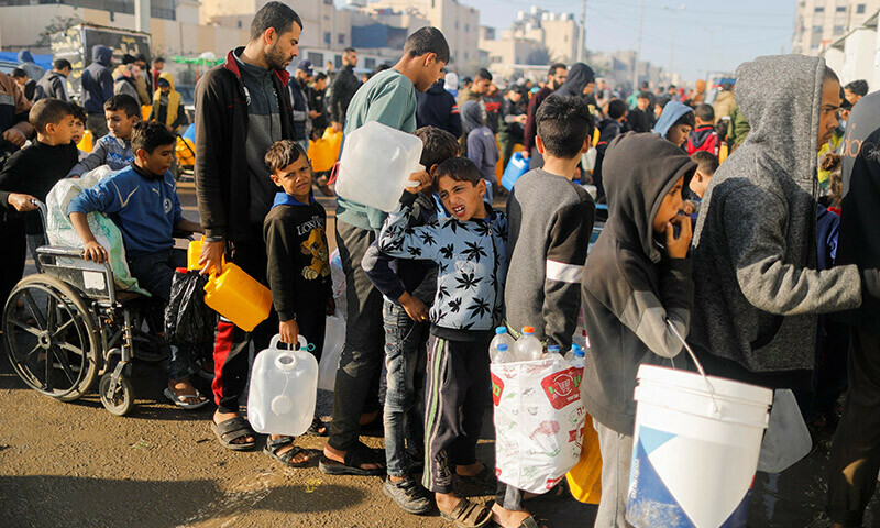 Palestinians queue as they wait to collect drinking water, amid shortages of drinking water in Rafah, in the southern Gaza Strip January 4, 2024.  &mdash; Reuters