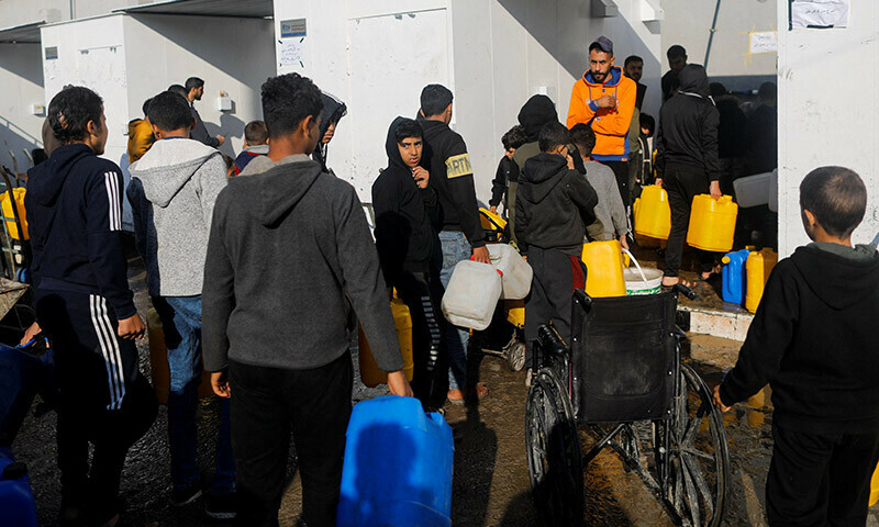Palestinians queue as they wait to collect drinking water, amid shortages of drinking water in Rafah, in the southern Gaza Strip January 4, 2024.  &mdash; Reuters