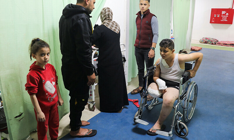 Palestinian teenage Ramadan Basal, whose limb was amputated after being wounded in an Israeli strike, sits in a wheelchair as he receives treatment at the European Hospital, in Rafah in the southern Gaza Strip on December 28, 2023  &mdash; Reuters