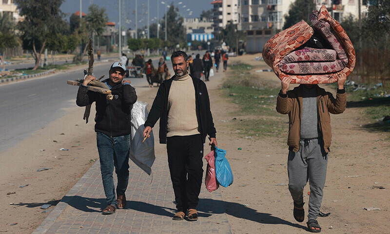 People carrying some of their belongings arrive in Rafah on the southern Gaza Strip on January 4. &mdash; AFP