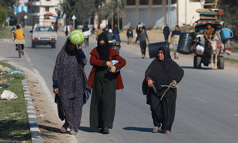 People carrying some of their belongings arrive in Rafah on the southern Gaza Strip on January 4. &mdash; AFP
