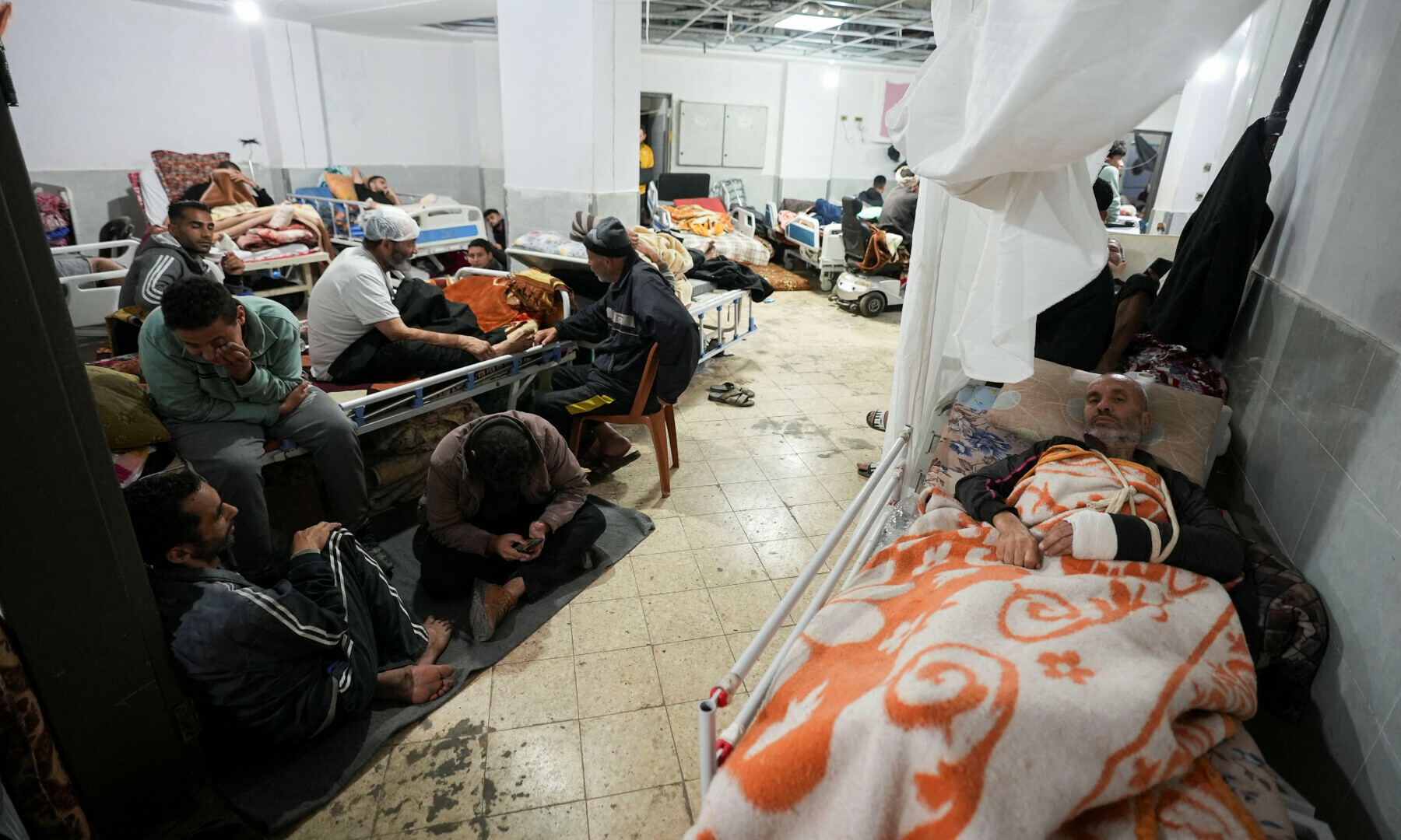  Palestinians wounded in Israeli strikes lie on beds as displaced people shelter at Shuhada Al-Aqsa Hospital in Deir Al-Balah in the central Gaza Strip on Jan 3, 2024. &mdash; Reuters 