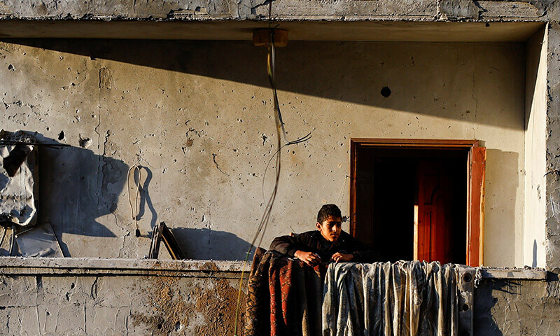 A Palestinian boy looks on from a house damaged in an Israeli strike in the southern Gaza Strip, January 5, 2024. &mdash; Reuters