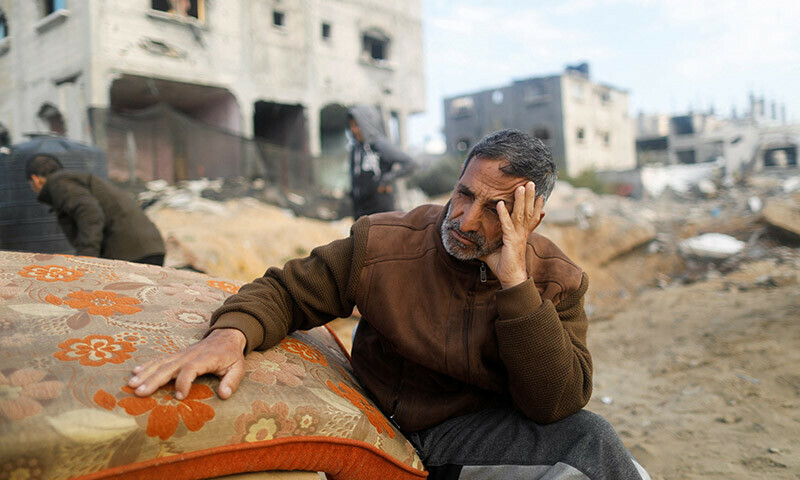 A displaced Palestinian man, who has fled his home due to Israeli strikes, reacts as he takes shelter in a tent camp in Rafah, southern Gaza Strip, January 5, 2024. &mdash; Reuters