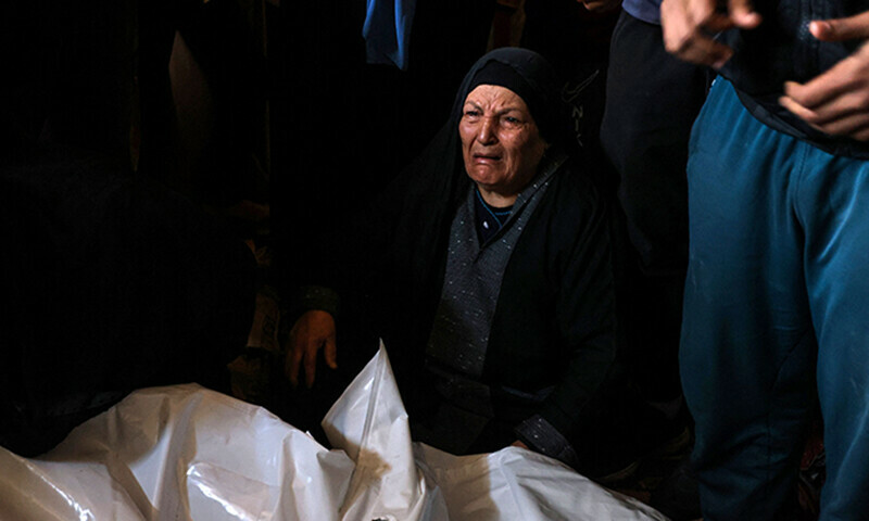 People mourn over the shrouded bodies of loved ones killed during Israeli bombardment as they lie at al-Najjar hospital in Rafah in the southern Gaza Strip on January 5. &mdash; AFP