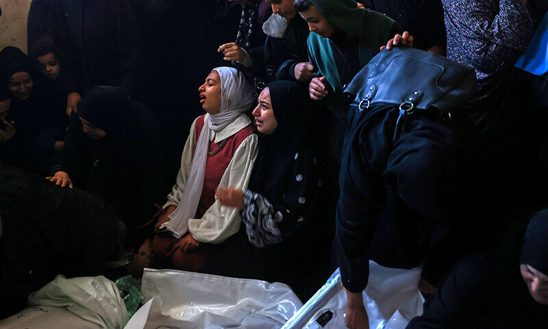 People mourn over the shrouded bodies of loved ones killed during Israeli bombardment as they lie at al-Najjar hospital in Rafah in the southern Gaza Strip on January 5. &mdash; AFP