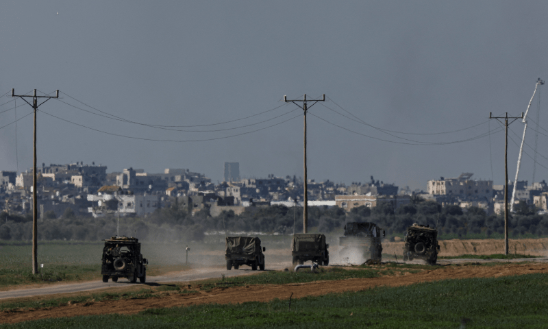 Israeli military vehicles drive along the border with the Israel-Gaza border on Jan 6, 2024. — Reuters