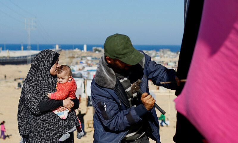 Displaced Palestinians, who fled their houses due to Israeli strikes, seek shelter near the border with Egypt, in Rafah in the southern Gaza Strip, January 7, 2024. &mdash; Reuters