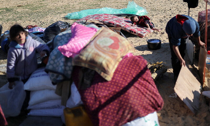 Displaced Palestinians, who fled their houses due to Israeli strikes, seek shelter near the border with Egypt, in Rafah in the southern Gaza Strip on January 7, 2024 &mdash; Reuters