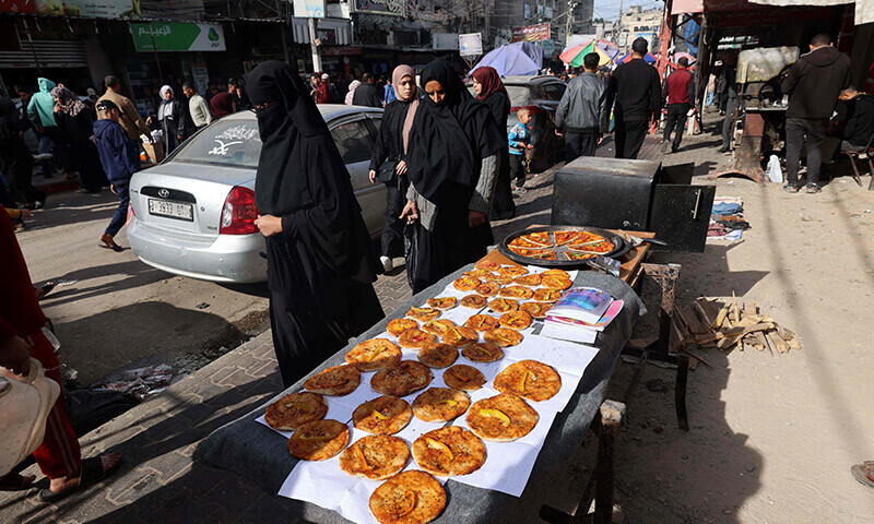 Palestinians shop at a market in Rafah refugee camp in the Gaza Strip on January 8, 2024. &mdash; AFP