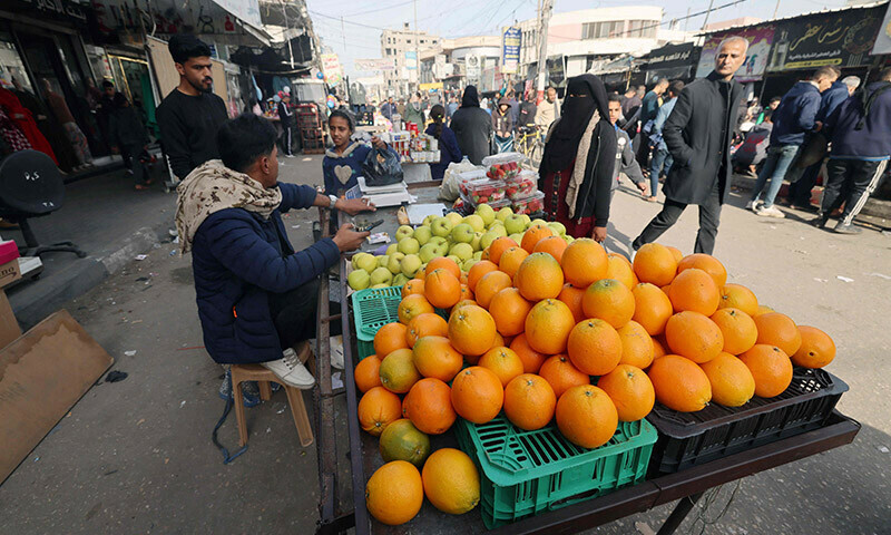 A Palestinian vendor sells fruits at a market in Rafah refugee camp in the Gaza Strip on January 8, 2024. &mdash; AFP