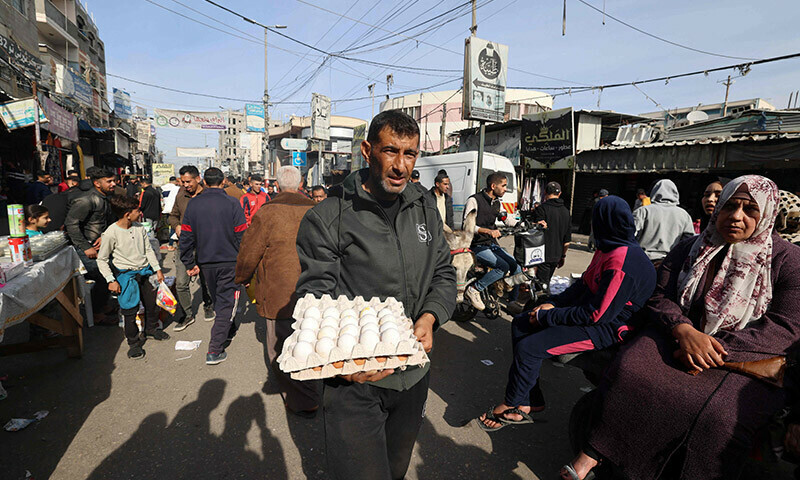 A Palestinian man carries eggs at a market in Rafah refugee camp in the Gaza Strip on January 8, 2024. &mdash; AFP