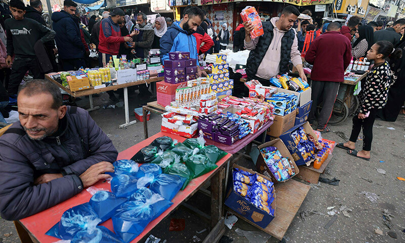 Palestinians shop at a market in Rafah refugee camp in the Gaza Strip on January 8, 2024. &mdash; AFP