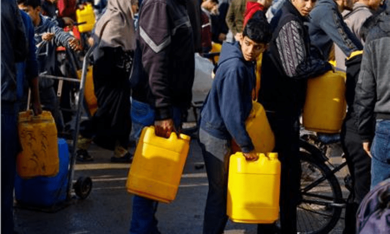 Palestinian children and youth wait to collect drinking water amid shortages in Rafah, in the southern Gaza Strip, on January 9, 2024. &mdash; Reuters