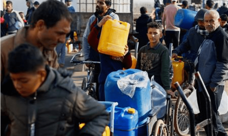  Palestinian children and youth wait to collect drinking water amid shortages in Rafah, in the southern Gaza Strip on January 9, 2024. &mdash; Reuters