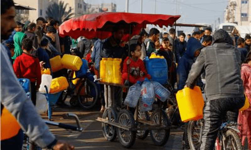 Palestinian children and youth wait to collect drinking water amid shortages in Rafah, in the southern Gaza Strip on January 9, 2024. &mdash; Reuters
