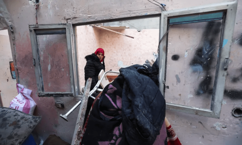 A Palestinian woman looks on, at the site of an Israeli strike, in Rafah in the southern Gaza Strip on January 10. &mdash; Reuters