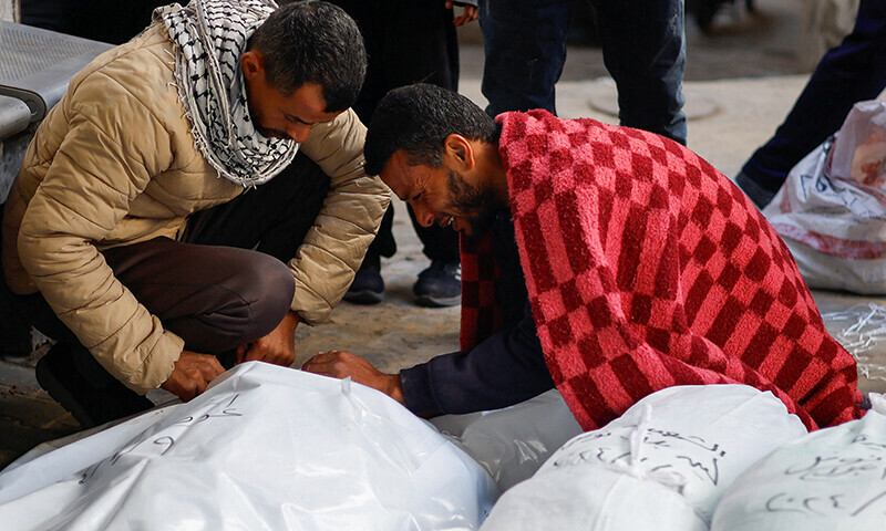 Mourners react next to the bodies of Palestinians killed in an Israeli strike&mdash; Reuters