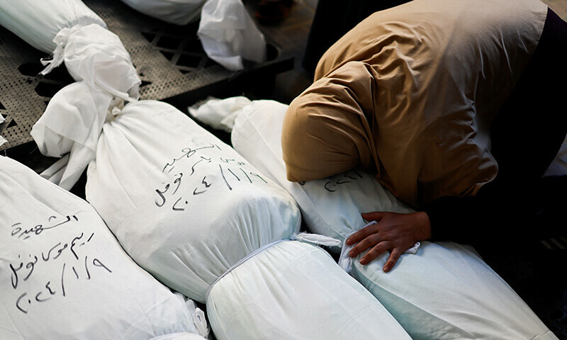A mourner reacts next to the bodies of Palestinians killed in an Israeli strike &mdash; Reuters