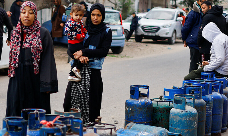 Palestinians wait to fill their cylinders with cooking gas amid shortage, as the conflict between Israel and Hamas continues, in Rafah, in the southern Gaza Strip, January 11, 2024.&mdash;Reuters