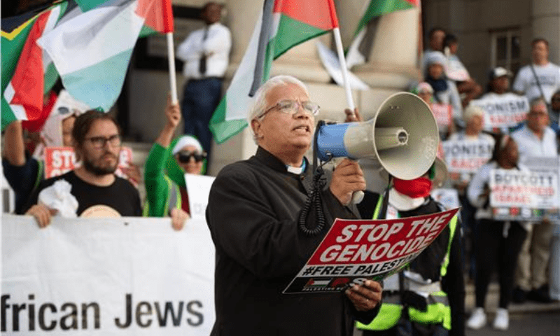 Reverend Rodney Whiteman addresses people gathering during an interfaith protest in solidarity with Palestinian people outside the High Court in Cape Town on January 11, 2024. &mdash; AFP