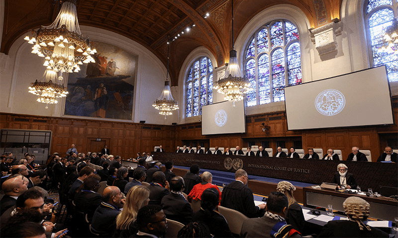 People sit inside the ICJ on the day of the trial to hear a request for emergency measures by South Africa, who asked the court to order Israel to stop its military actions in Gaza in The Hague, Netherlands January 11, 2024 &mdash; Reuters