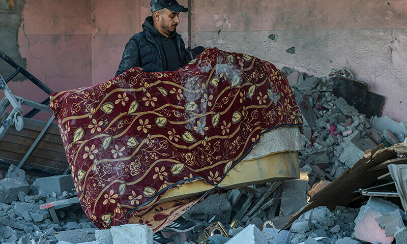 People look for salvageable items amid the rubble following Israeli bombardment in Rafah in the southern Gaza Strip on January 13. &mdash; AFP