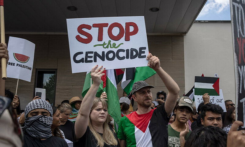 Pro-Palestinian protesters hold placards as they gather in front of the US Consulate in Sandton, Johannesburg, on January 13. &mdash; AFP
