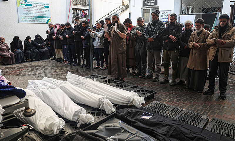Palestinians pray over bodies of relatives killed in Israeli bombardment in Rafah in the southern Gaza Strip on January 24, 2024 &mdash; AFP