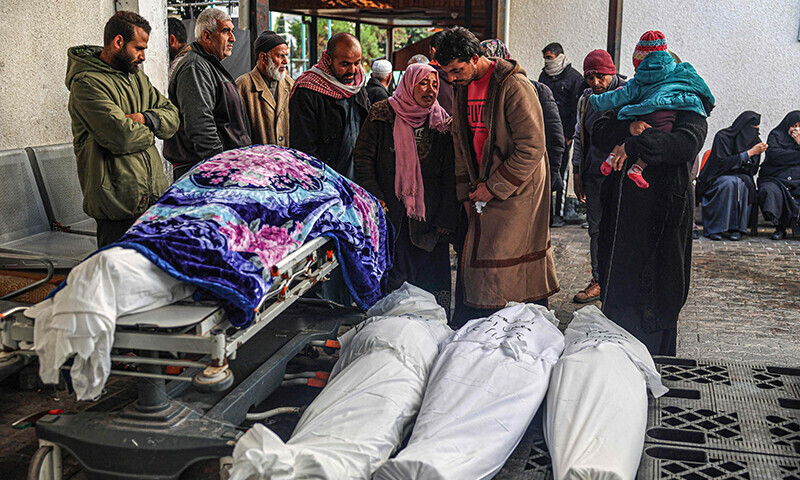 Palestinians wait at a hospital to collect the bodies of their relatives killed in Israeli bombardment in Rafah in the southern Gaza Strip on January 24, 2024 &mdash; AFP