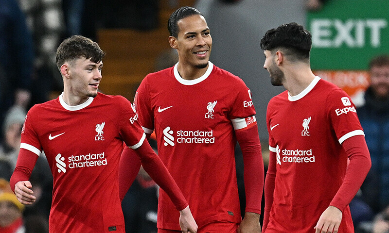 Liverpool&rsquo;s Dutch defender 04 Virgil van Dijk (C)  celebrates scoring the team&rsquo;s fourth goal with Liverpool&rsquo;s Northern Irish defender #84 Conor Bradley (L) and Liverpool&rsquo;s Hungarian midfielder #08 Dominik Szoboszlai during the English FA Cup fourth round football match between Liverpool and Norwich City at Anfield in Liverpool, north west England on January 28, 2024.&mdash;AFP