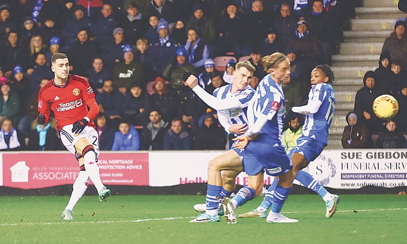 WIGAN: Manchester United’s Diogo Dalot (L) scores against Wigan Athletic during their FA Cup third-round match at the DW Stadium.—Reuters WIGAN: Manchester United’s Diogo Dalot (L) scores against Wigan Athletic during their FA Cup third-round match at the DW Stadium.—Reuters