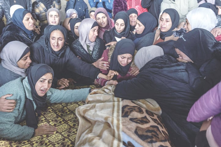  HEBRON: Relatives mourn during the funerals of Ahmed and Jalal Jabarin, who were shot dead by Israeli troops when their car broke through a checkpoint near the city of Hebron, in occupied West Bank, on Monday.&mdash;AFP 