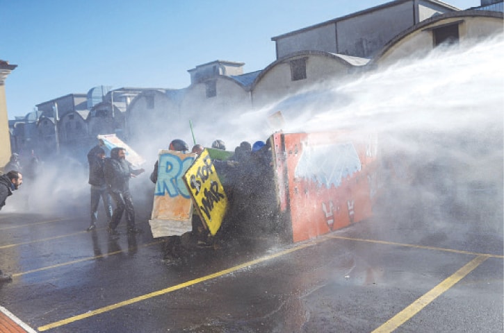 Police use a water cannon on Italians protesting against the presence of an Israeli pavilion at Vicenzaoro.&mdash;AFP