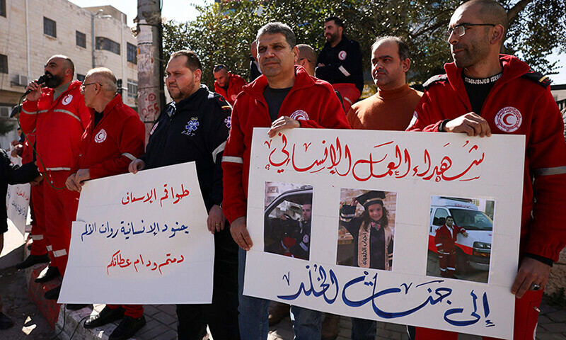 Paramedics from the Palestinian Red Crescent Society (PRCS) hold placards during a protest to denounce the death of their colleagues in the ongoing Israeli bombardment in Gaza, in the occupied  West Bank city of Hebron on February 11, 2024.&mdash;AFP