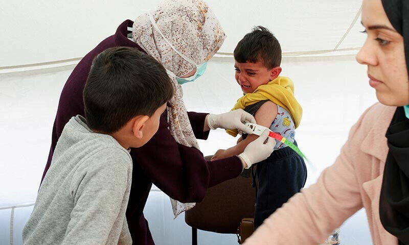A Palestinian boy has his arm measured for malnutrition at a medical tent set up by MedGlobal in cooperation with Unicef on February 14, 2024 &mdash; Reuters
