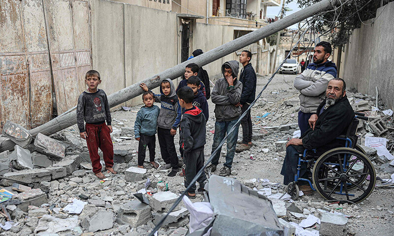 Palestinians look at the rubble of their house which was destroyed in an overnight Israeli air strike in the Rafah refugee camp in the southern Gaza Strip on February 27, 2024 &mdash; AFP