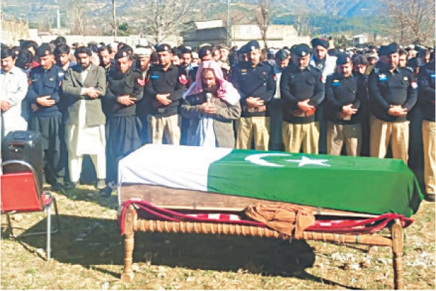 Funeral prayers of a policeman being offered in Samarbagh on Friday. &mdash; Dawn