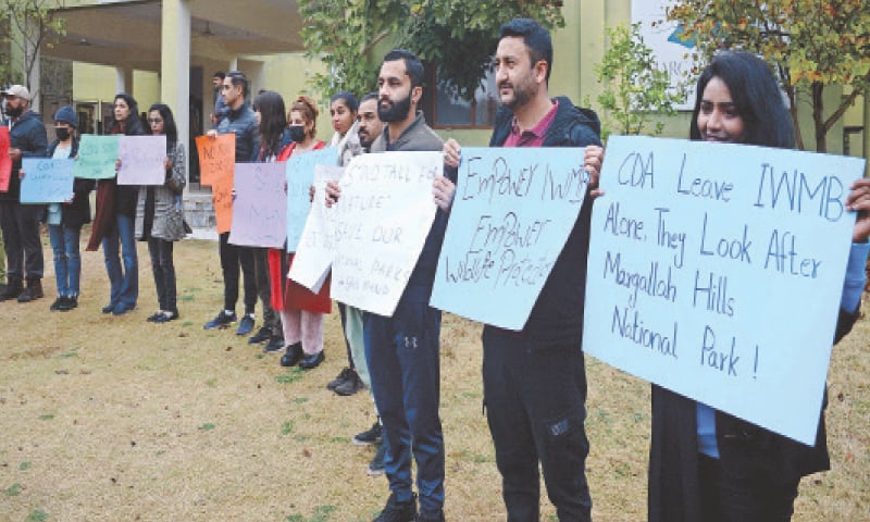 Civil society activists protest outside the visitors information centre on Trail 5 in Islamabad that was sealed by the CDA a few days ago. &mdash; Photo by Mohammad Asim