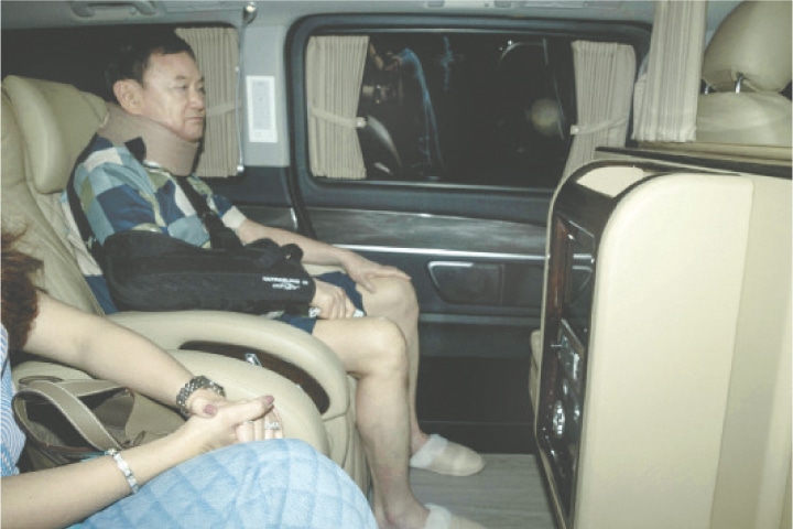 FORMER Thai prime minister Thaksin Shinawatra arrives at his family compound following his release, on Sunday.&mdash;AFP