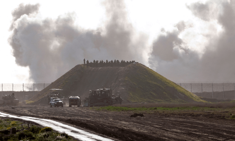  This picture taken from a position in southern Israel near the border with the Gaza Strip shows smoke billowing following Israeli bombardment as troops gather on a hill, on March 4, 2024. &mdash; AFP 