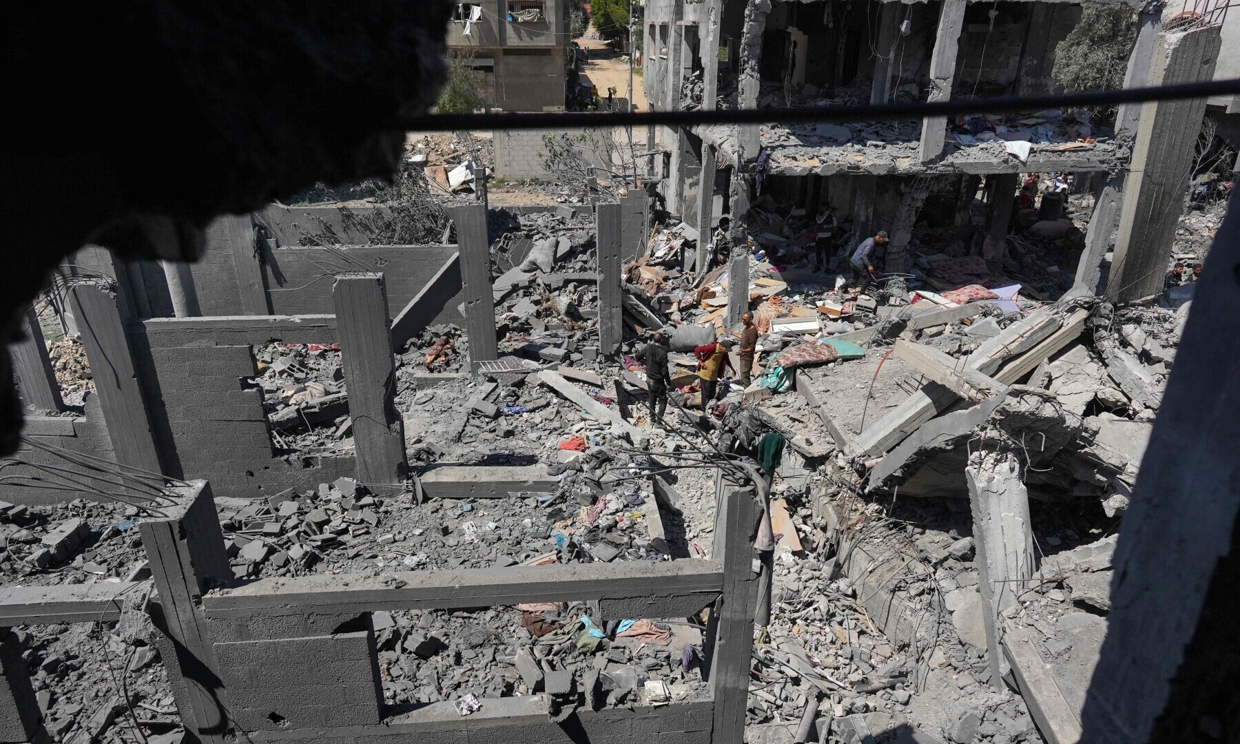 Palestinians inspect the rubble following overnight Israeli bombardment at the Nuseirat refugee camp in the central Gaza Strip on March 20, 2024. — AFP