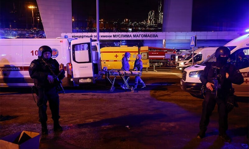 Russian law enforcement officers stand guard near the Crocus City Hall concert venue following a shooting incident, outside Moscow, Russia, March 23, 2024.&mdash;Reuters