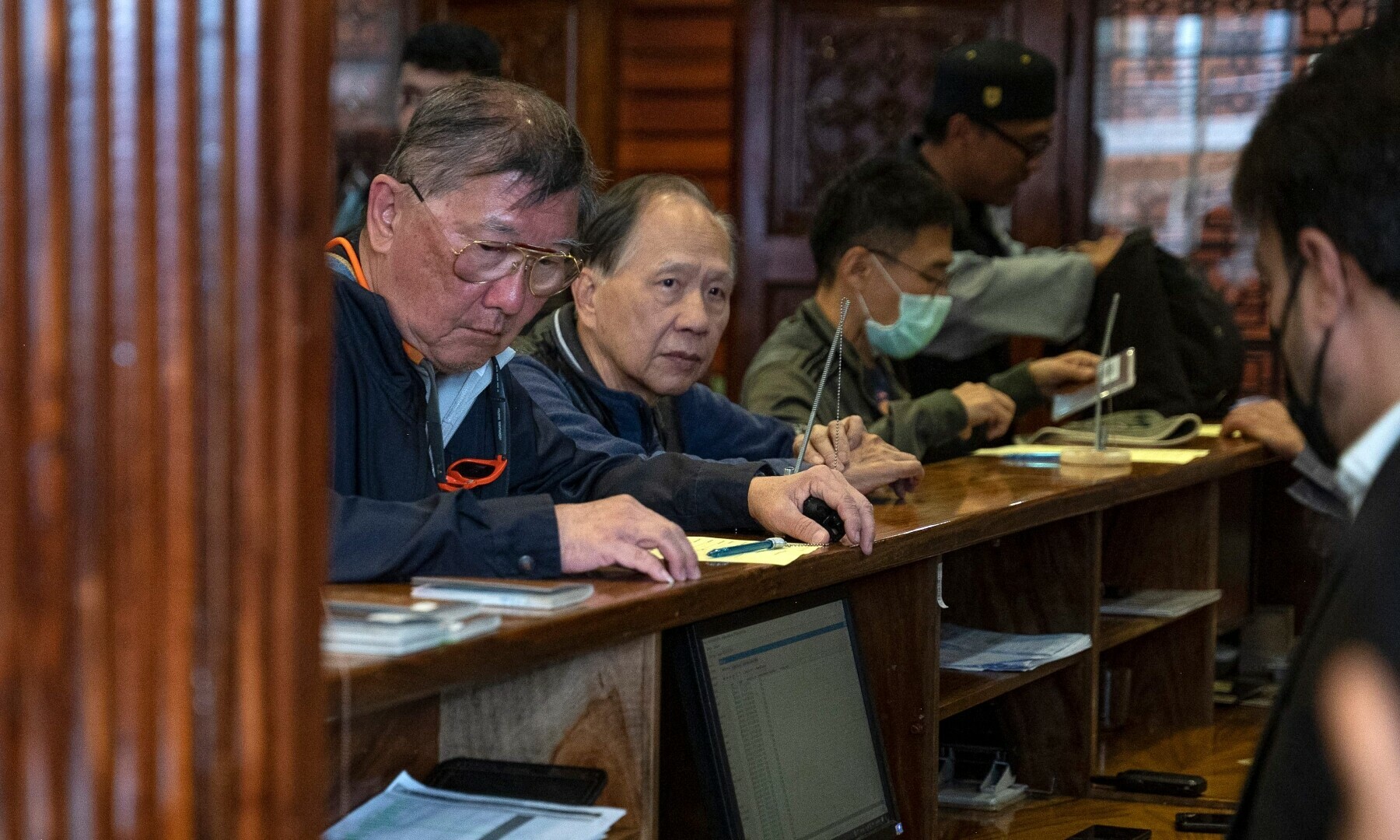 In this picture taken on March 25, Thai tourists register at the reception of a guesthouse in Kabul. — AFP