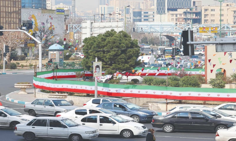 Tehran: Cars drive past a wall covered by a banner in the colours of the national flag, two days after Iranians voted in the country&rsquo;s parliamentary election.&mdash;AFP