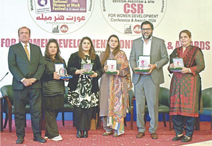Award winners and panelists at the CSR for Women Development Conference pose for a photograph on Sunday. — APP