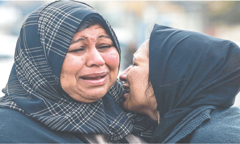Two women cry while mourning relatives killed during Israeli bombardment at Al Najar Hospital in Rafah, on Tuesday.&mdash;AFP