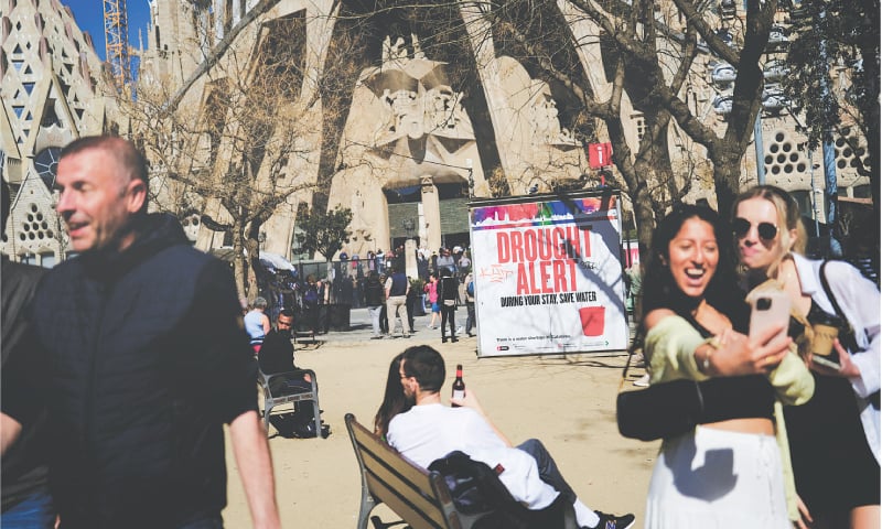 TOURISTS are seen next to a sign outside a church in Barcelona alerting them to severe drought in Spain&rsquo;s north-eastern region and urging them to save water due to low reservoir levels.&mdash;Reuters